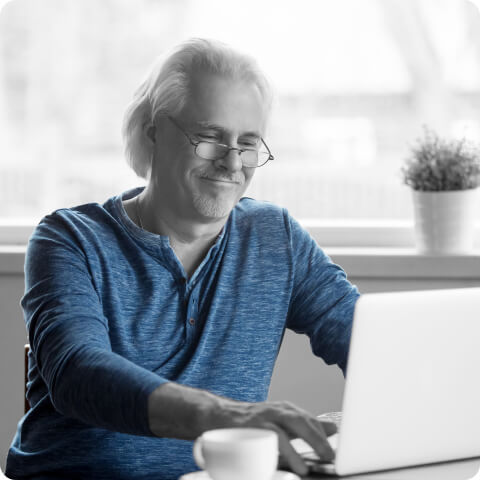 happy man typing on keyboard