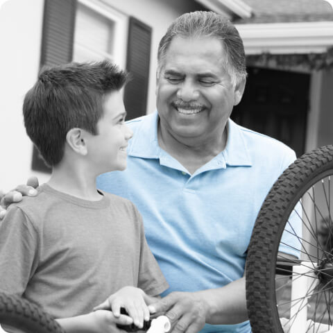 man helping boy with bike repair